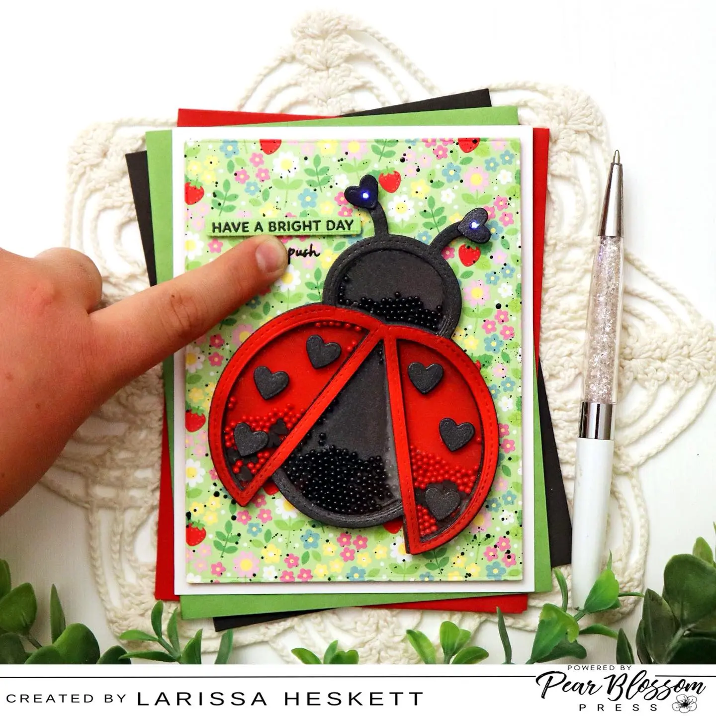 Hello Crafty Friends!! Larissa here today to share this ADORABLE Twinkling Ladybug Shaker Card!! I just LOVE Double Interactive Cards and this one is certain to bring a smile to the recipient’s Face!! I’ve used the Twinkling Lights to make the Heart Antennae Twinkle!! SQUEAL!! There are so many FUN ways you can bring your Shaker Images to LIFE!! I hope you feel INSPIRED to give this Design a try!!?? Happy Crafting, Friends!! #pearblossompress #twinklinglights #interactivecards #prettypinkposh #wowembossingpowder