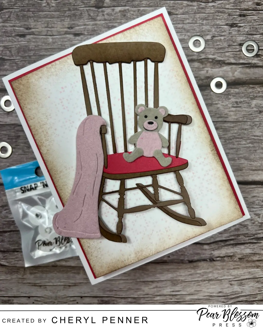 Hello!  Cheryl (aka Artsy Island Girl) here today on the Pear Blossom Press Channel creating a Baby Pendulum Card using Snap & Slides & Washers.  This is such an easy mechanism to create and gives you an interactive element on the front of the card with limited rocking movement.  This card has a Baby theme but the Pendulum can be used with many different designs.